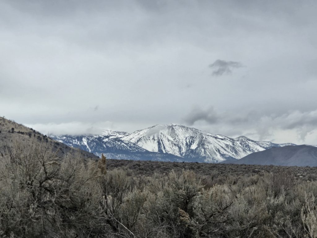 Snow-capped Carson Range seen from Mexican Ditch Trail during winter hiking in Carson City