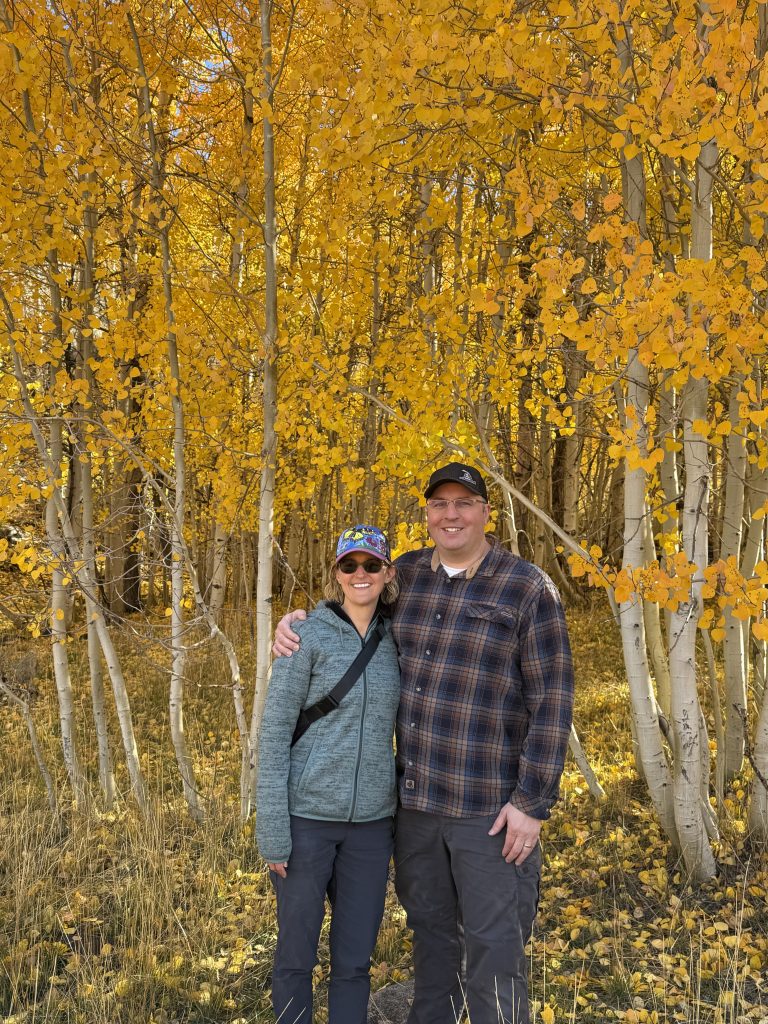 Posing in front of a stand of golden aspen trees