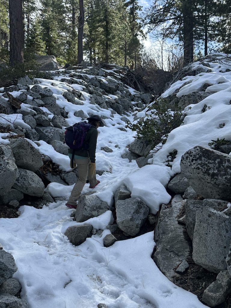Hiking up snowy, rocky terrain on Ophir Creek Trail