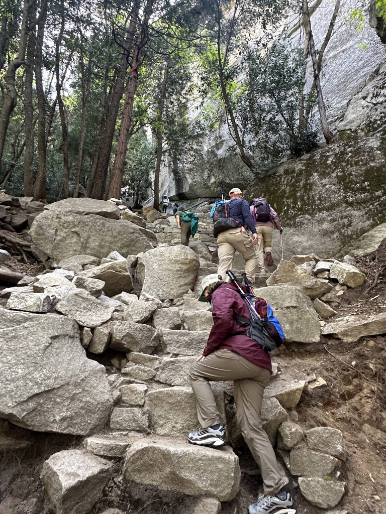 Climbing large stone steps up to the top of Vernal Falls in Yosemite