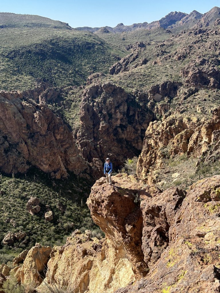 Standing on a rock ledge in Boulder Canyon